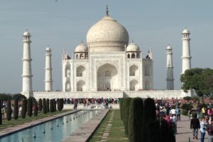 People walking on a white concrete tomb building