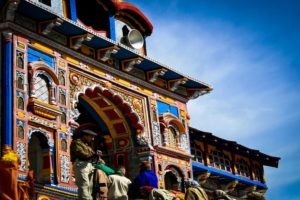 People walking near multi color tomb building